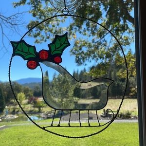 Stained glass and metal Christmas sleigh.